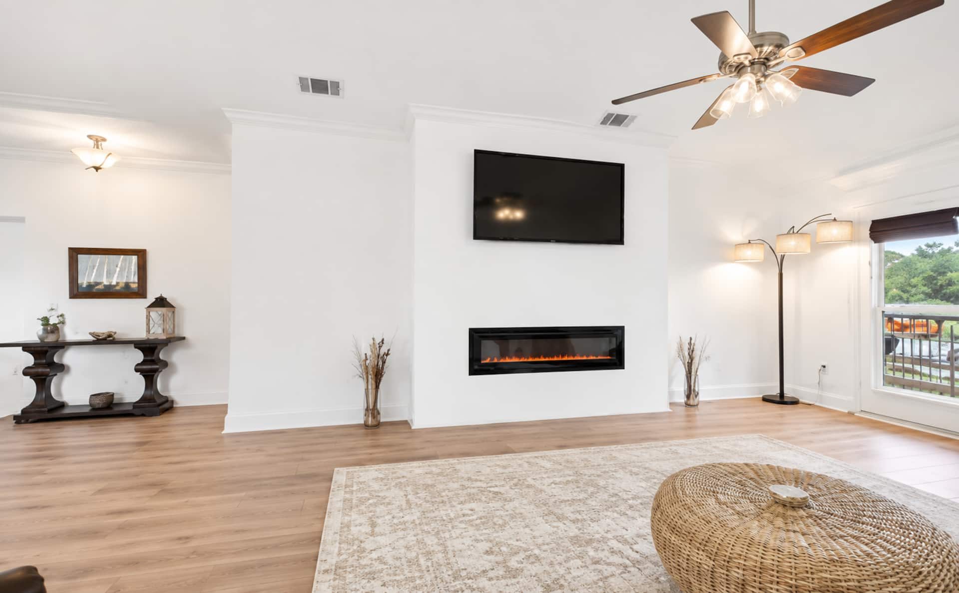Bright living room with fireplace, TV, and airy open-concept design