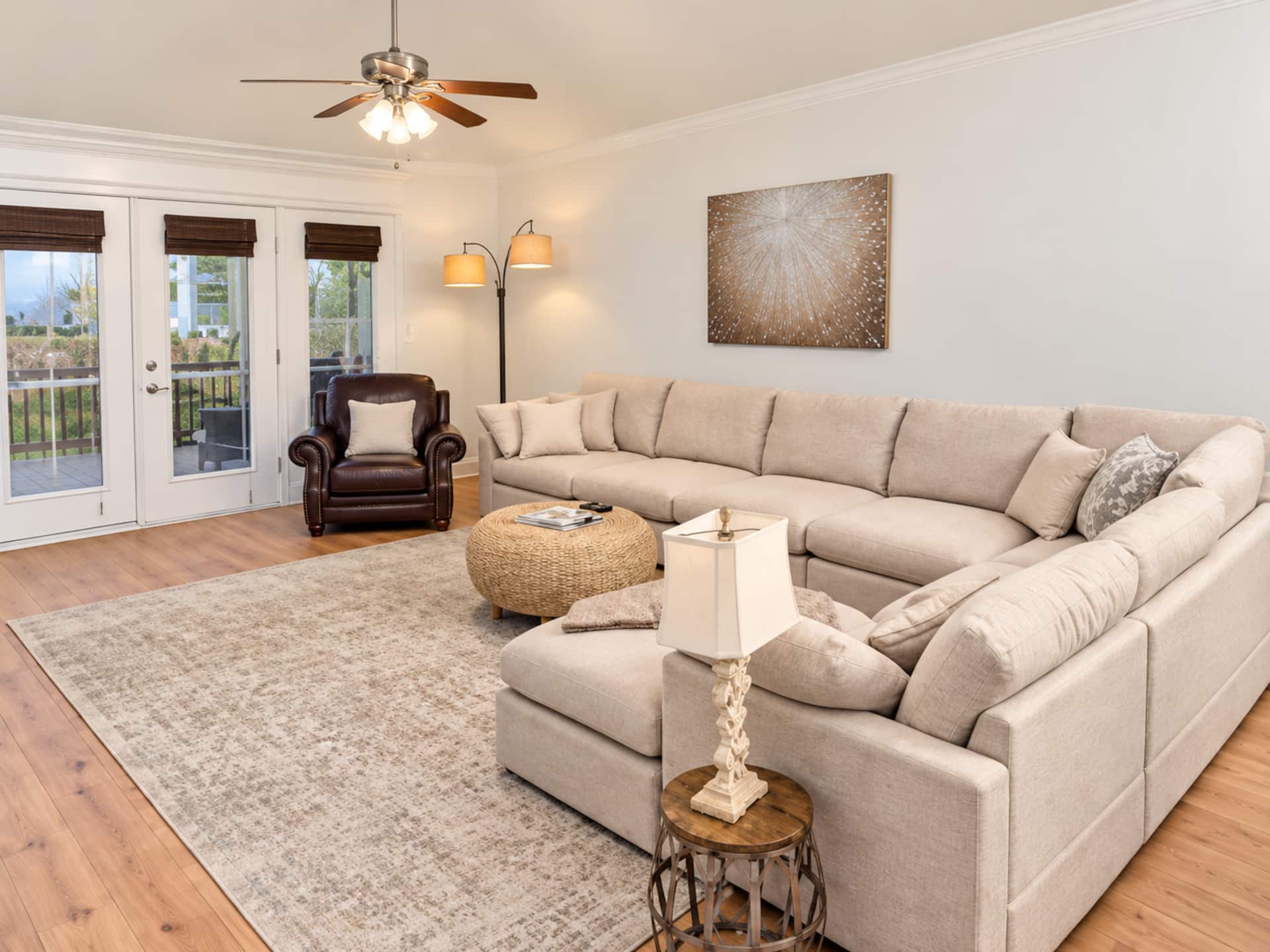 Bright, spacious living room with oversized sectional and French doors