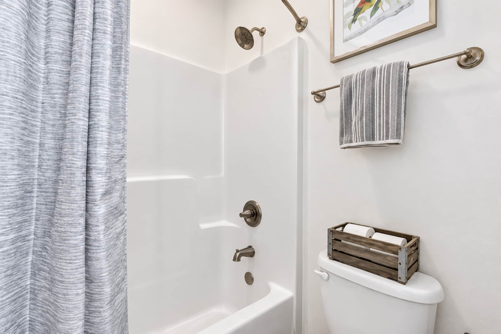 Bright, tidy bathroom with tub-shower combo and modern finishes