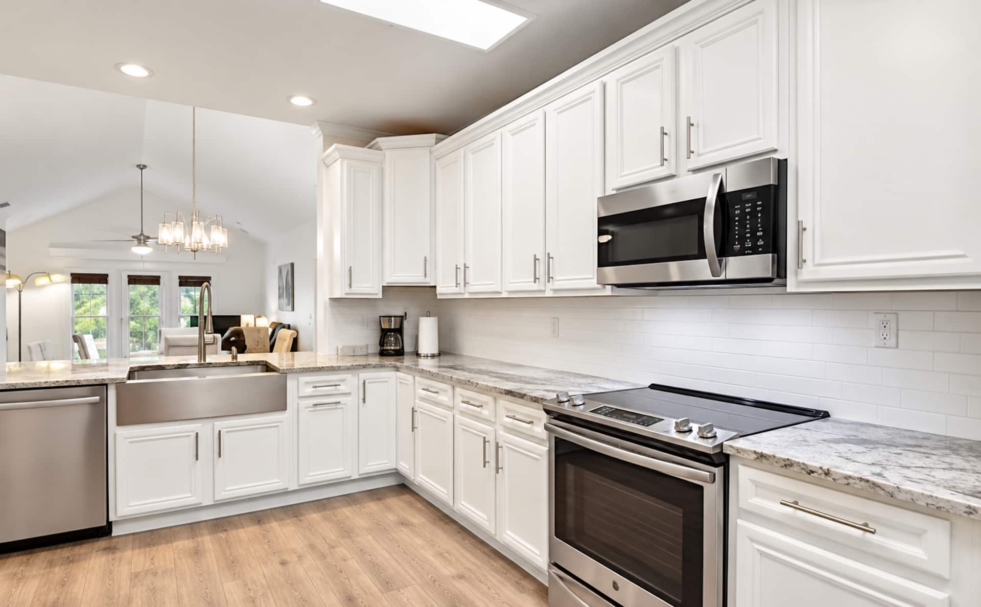 Bright modern kitchen with farmhouse sink and stainless appliances