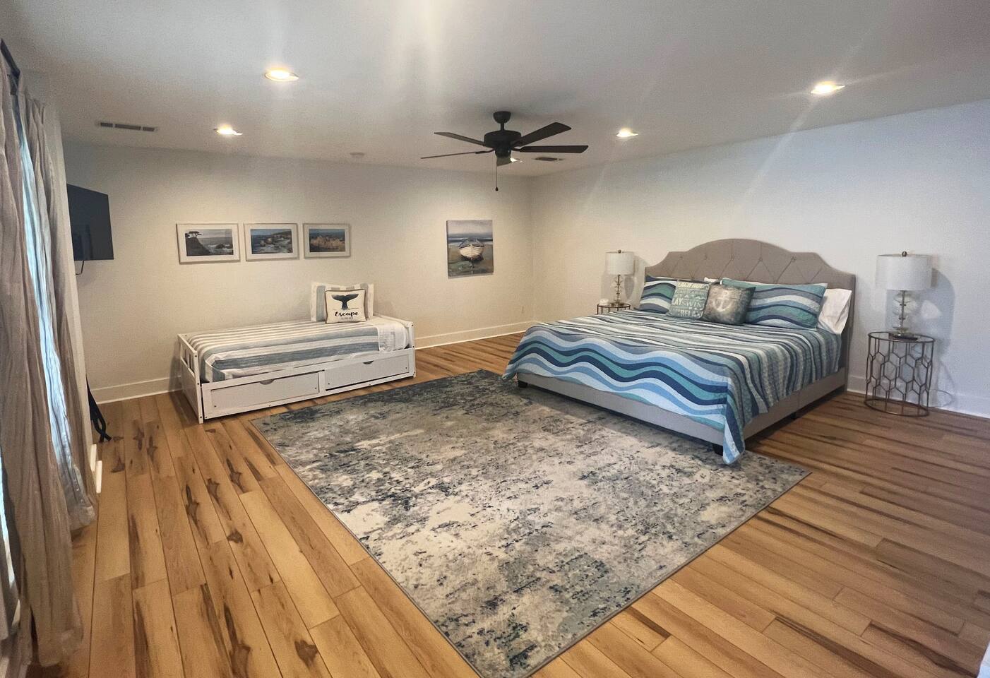 King bedroom with trundle (twin). Another twin mattress can be used with the trundle pull out underneath for an additional twin bed. Large tv in corner of room