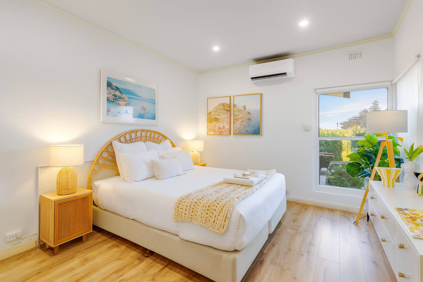 Queen bedroom with morning sun through picture windows