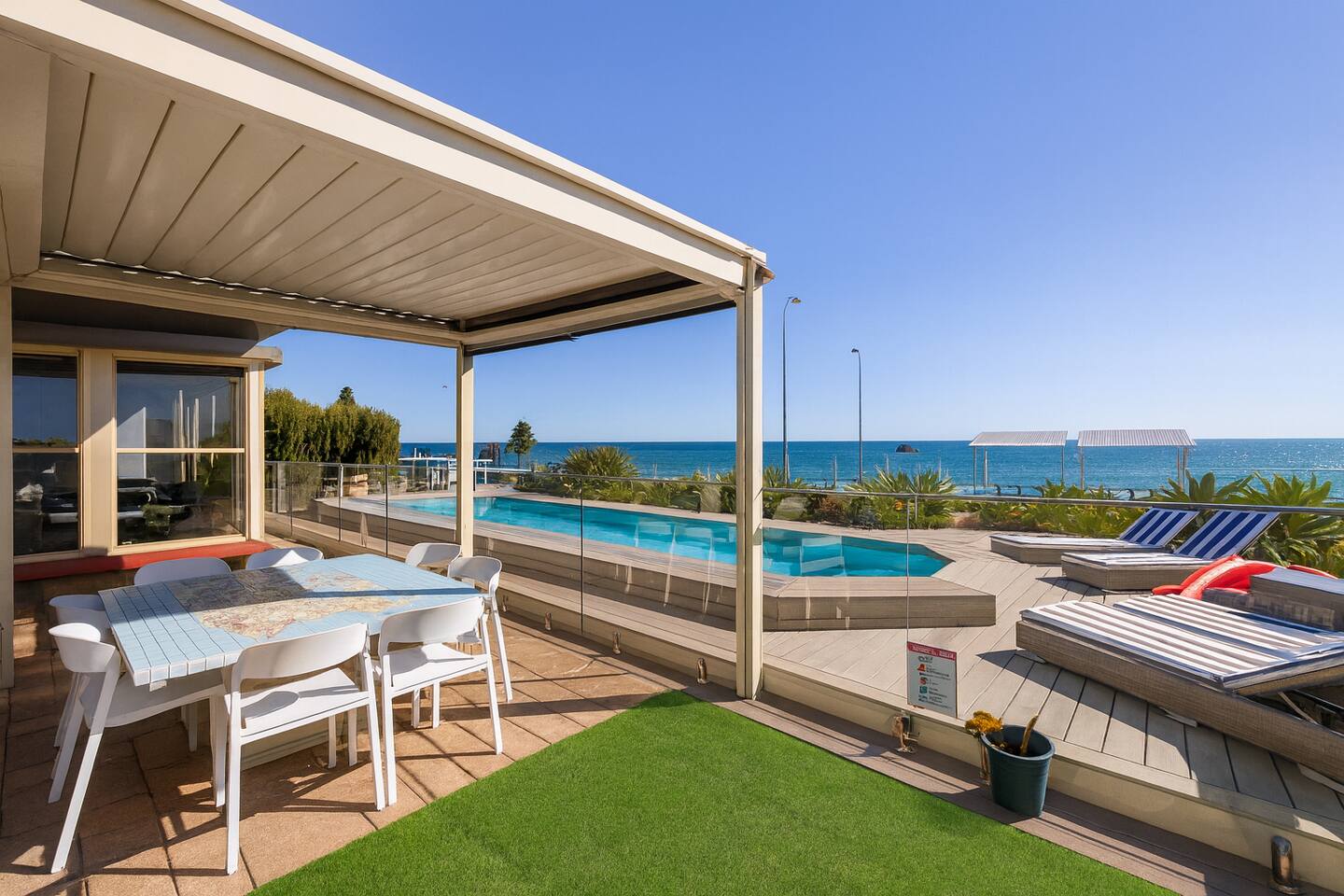 Breezy deck overlooking the pool and sea
