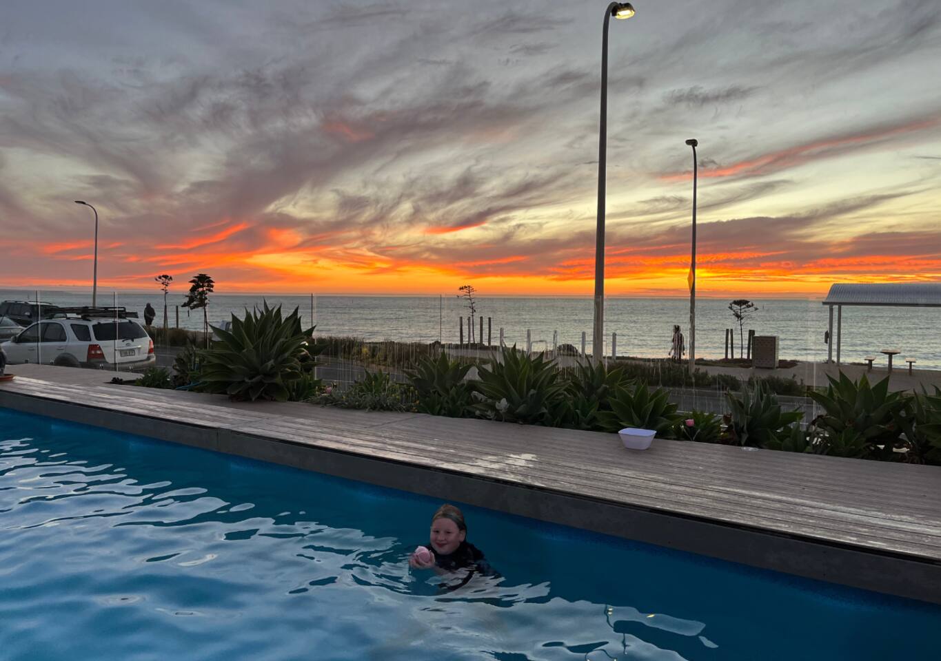 Evening swim in the warm pool as the sunset ignites the sky
