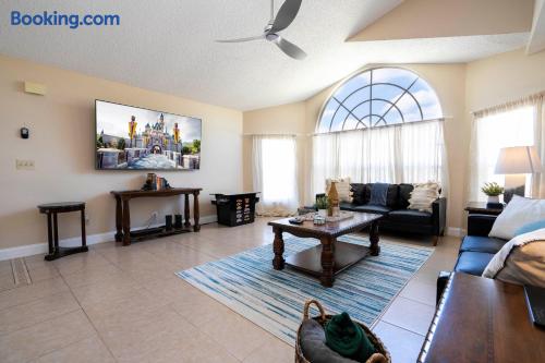 Relax and have fun in our bright living space featuring a private arcade, comfortable seating, and a large TV perfect for movie nights. Enjoy natural light through large windows while creating unforgettable memories after a day of Disney adventures.