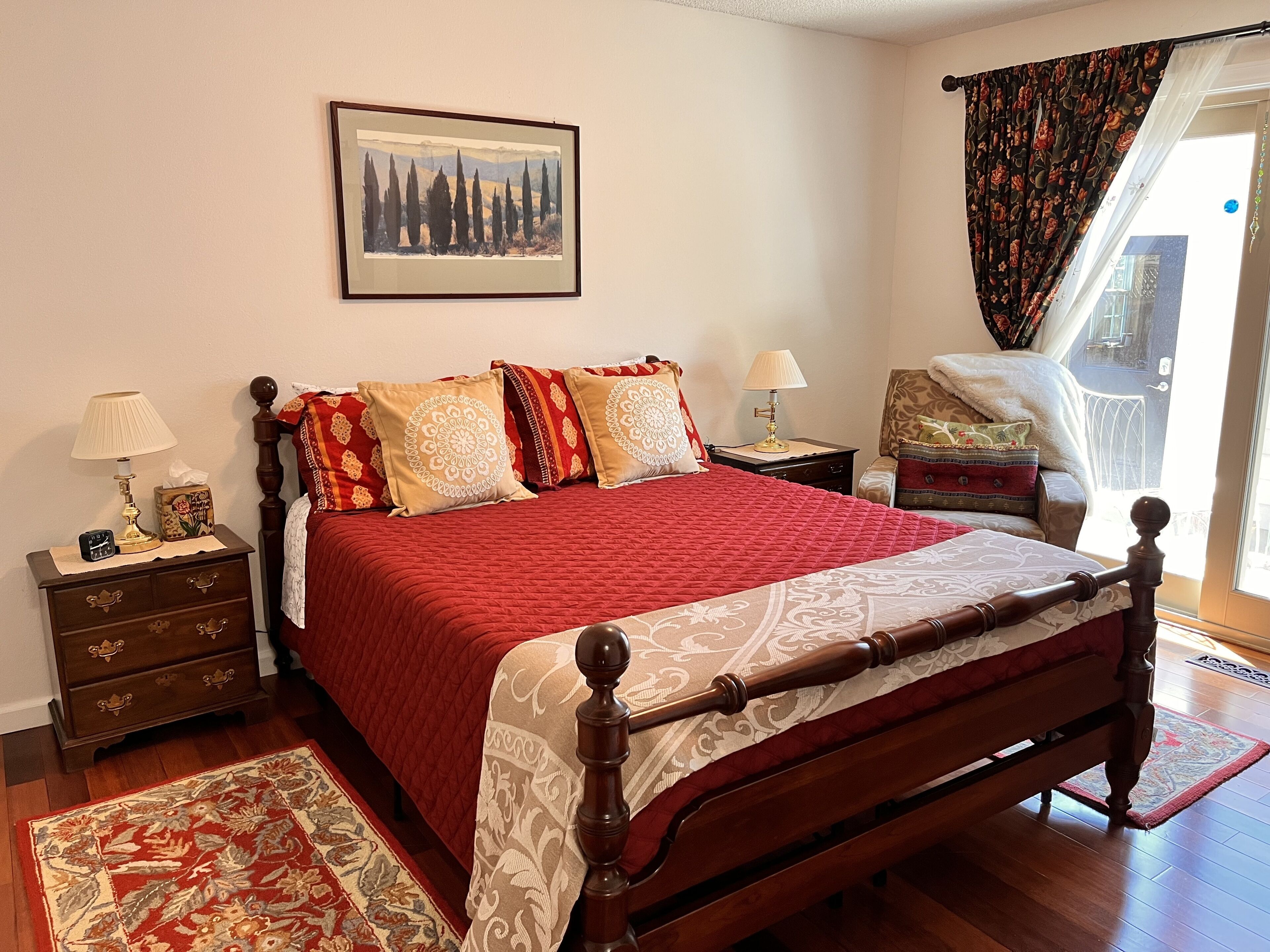 Bedroom #2 with a sitting chair and a sliding glass door.