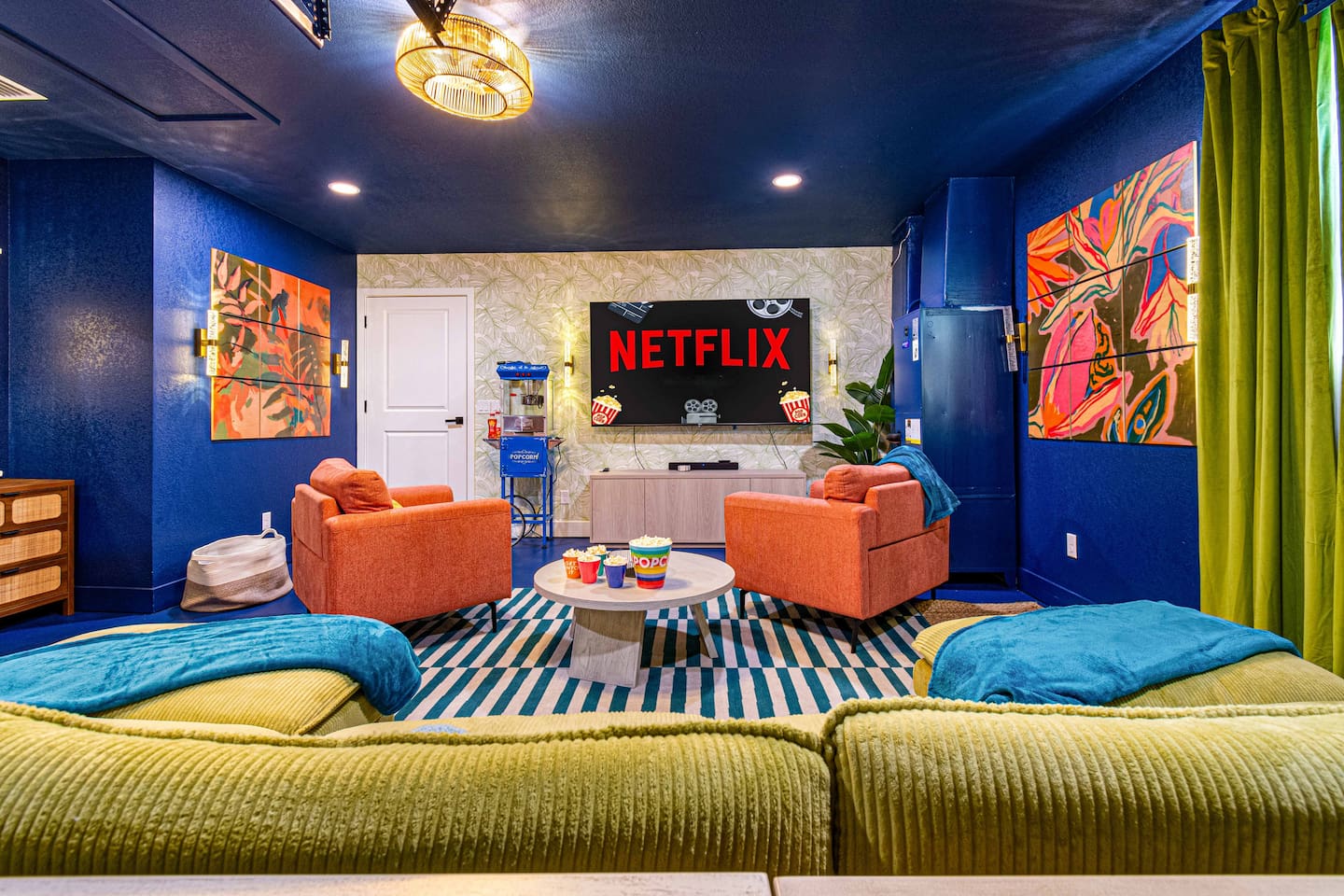 Ready for the big screen? With an 85" TV, sound bar, plenty of seating, and popcorn machine, the movie theater room is set for your next movie night with the latest hits!