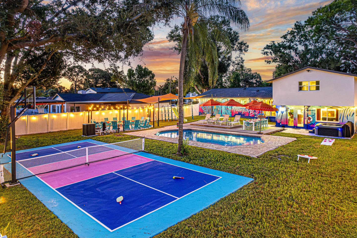 The outdoor space is an oasis with pickleball, basketball, and a firepit for 16. Enjoy the heated pool, hot tub, 4 chaise lounges, dining for 12, umbrellas for shade, and fun outdoor games for everyone to enjoy!