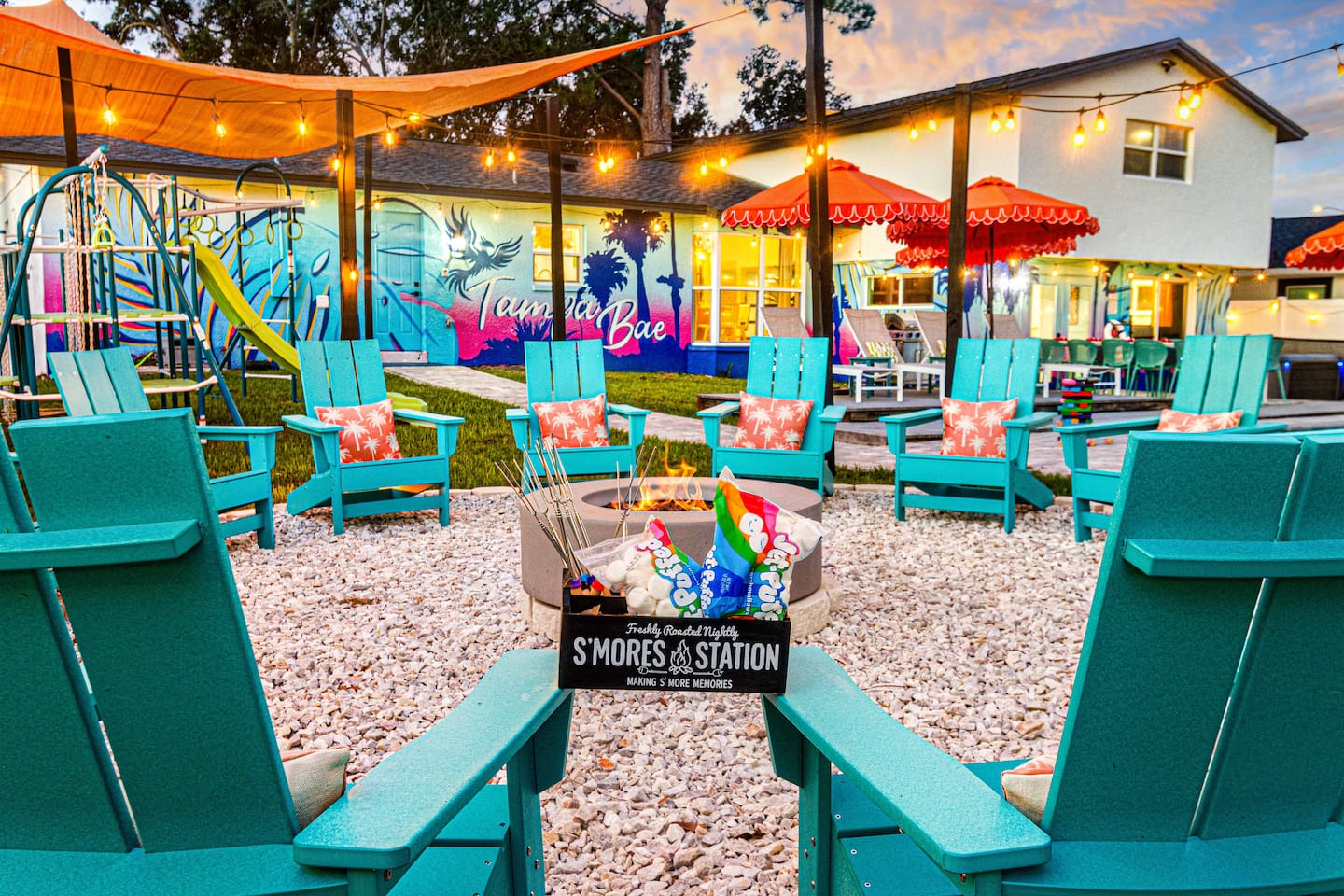 Gather around the 16-person fire pit, surrounded by cozy blue Adirondack chairs and string lights above. Perfect for making s’mores and enjoying warm, memorable evenings with family and friends.