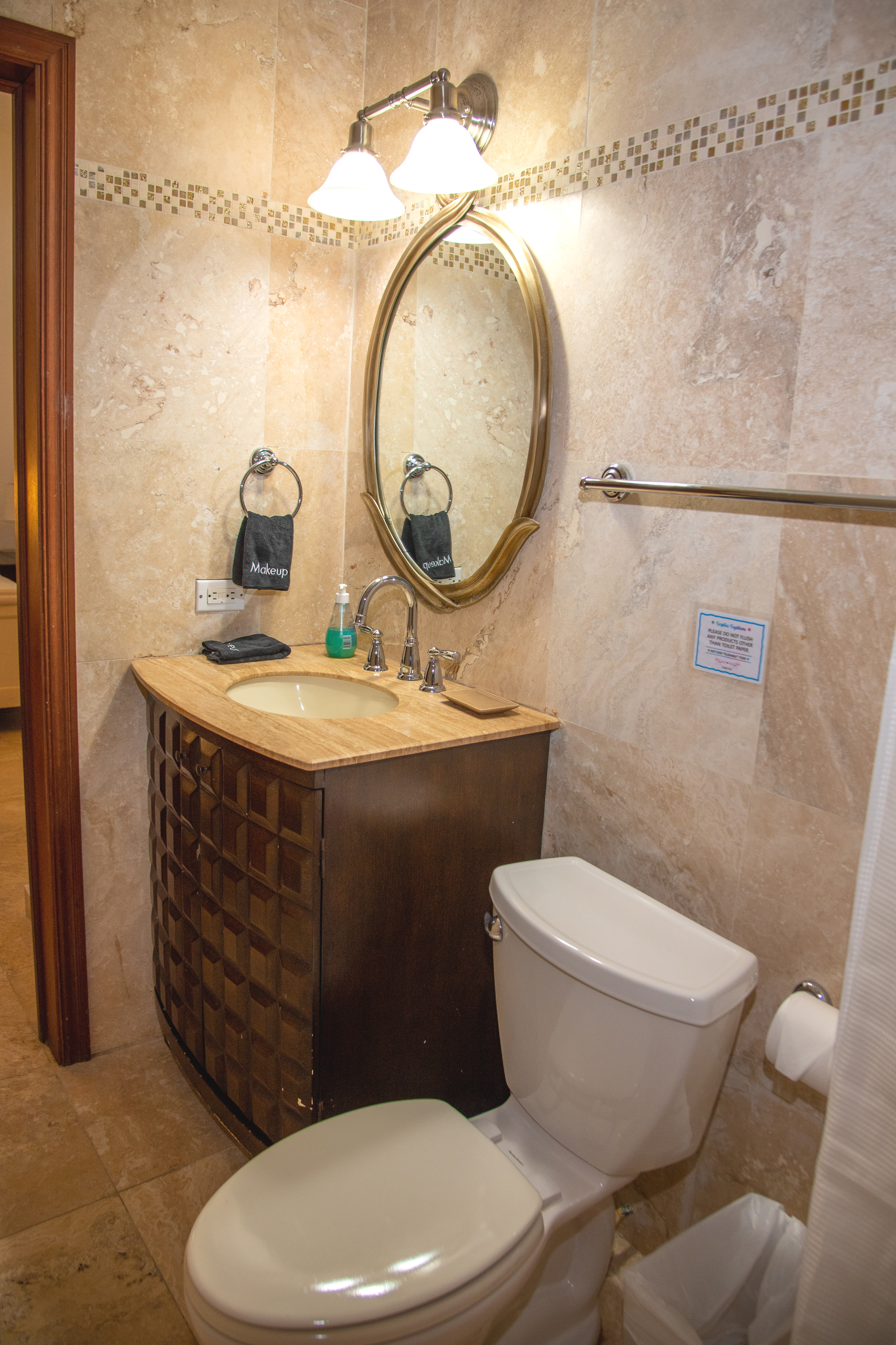 Elegant stone-tiled bathroom with marble vanity and warm lighting