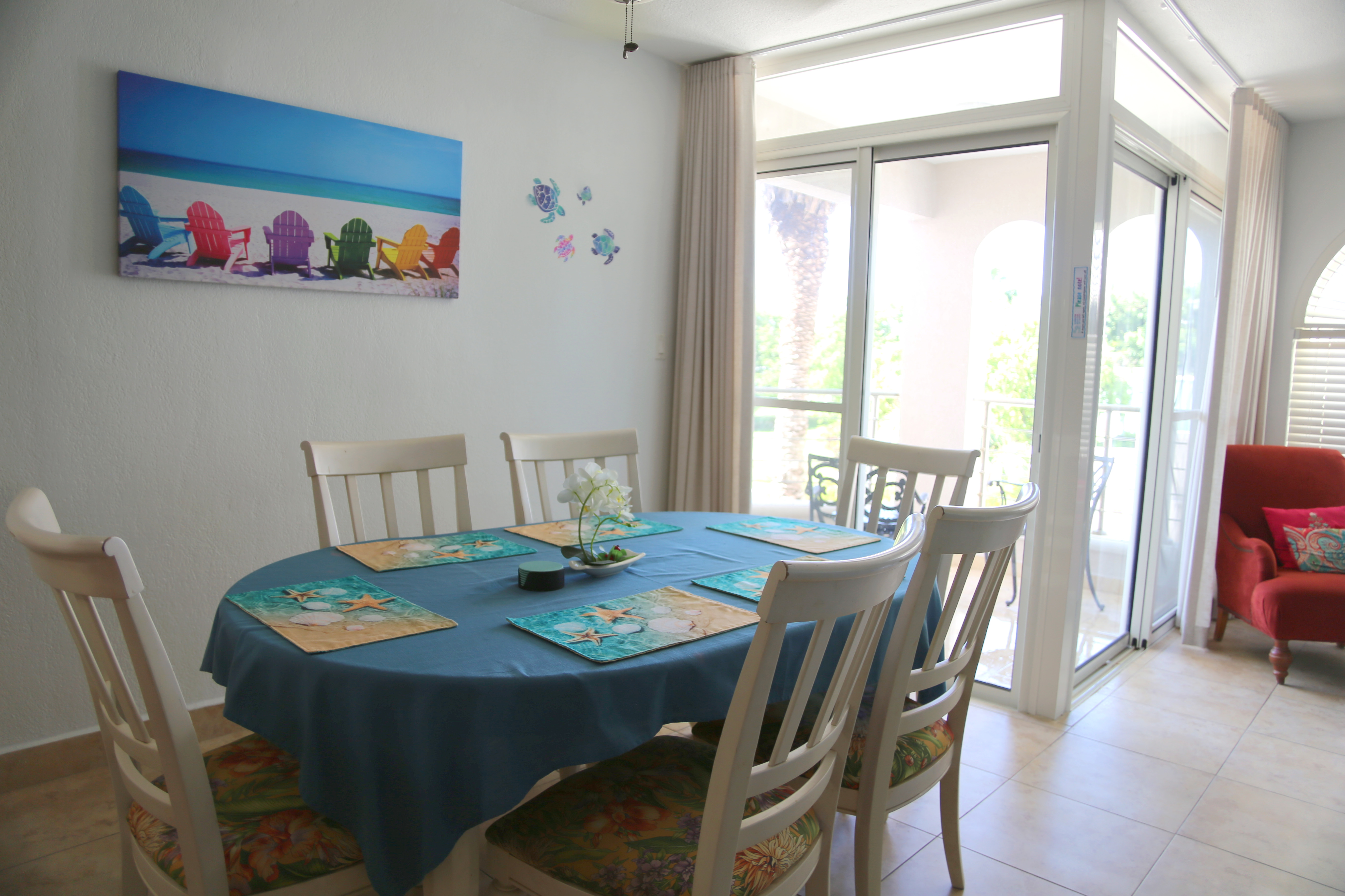 Bright coastal dining nook with patio access and plenty of natural light