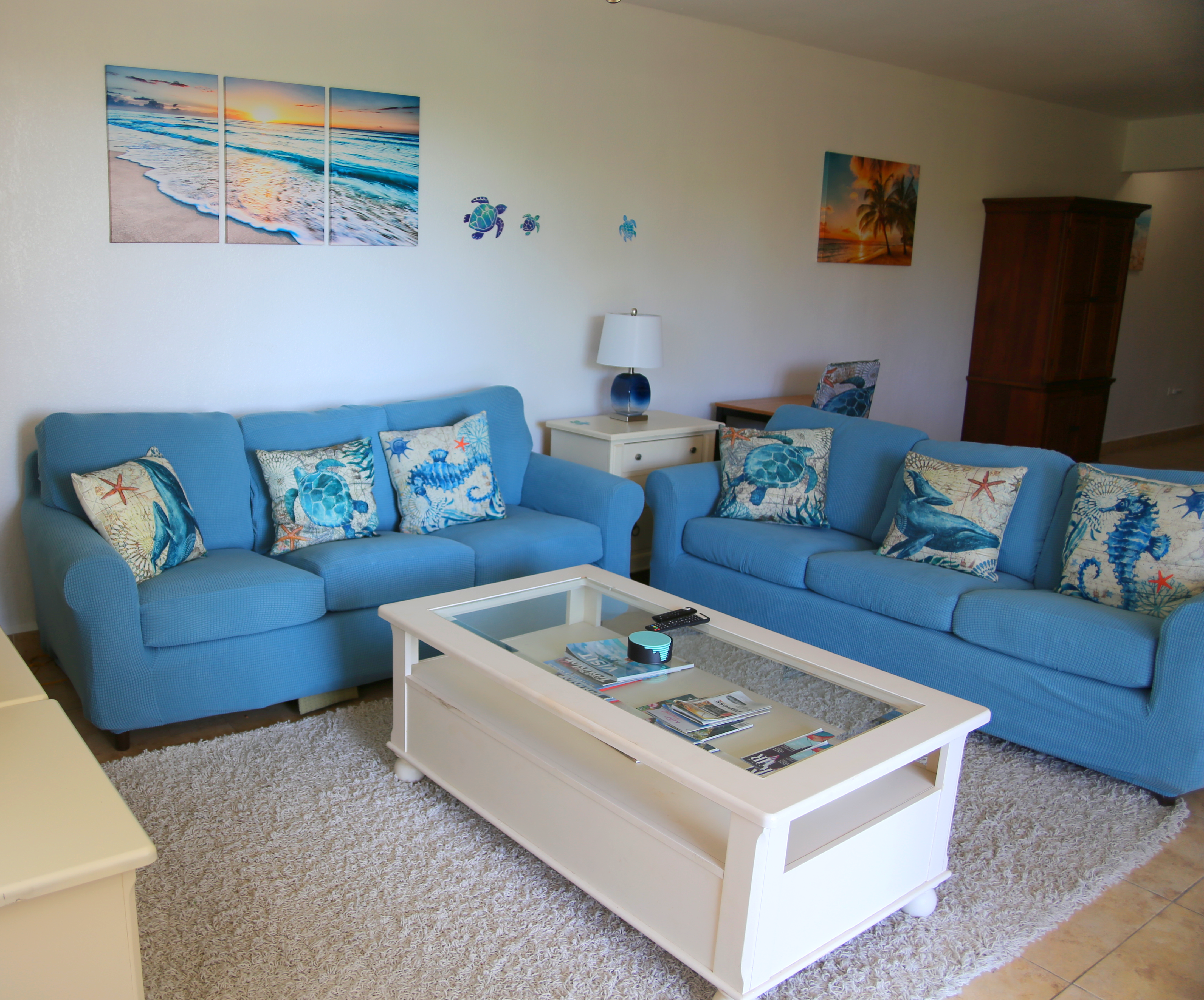 Coastal living room with plush blue sofas and bright beachy decor