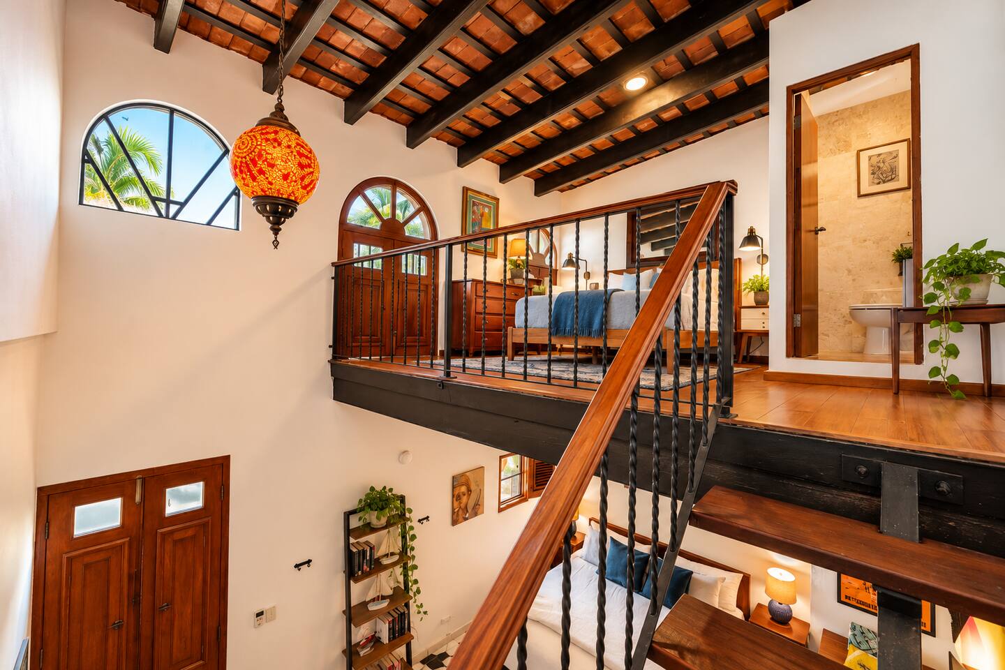 Two levels, one unforgettable stay! The open loft connects the upstairs Queen bedroom and main-level King bedroom beneath soaring ceilings and original wooden beams. A distinctive Old San Juan layout that keeps friends and family connected.