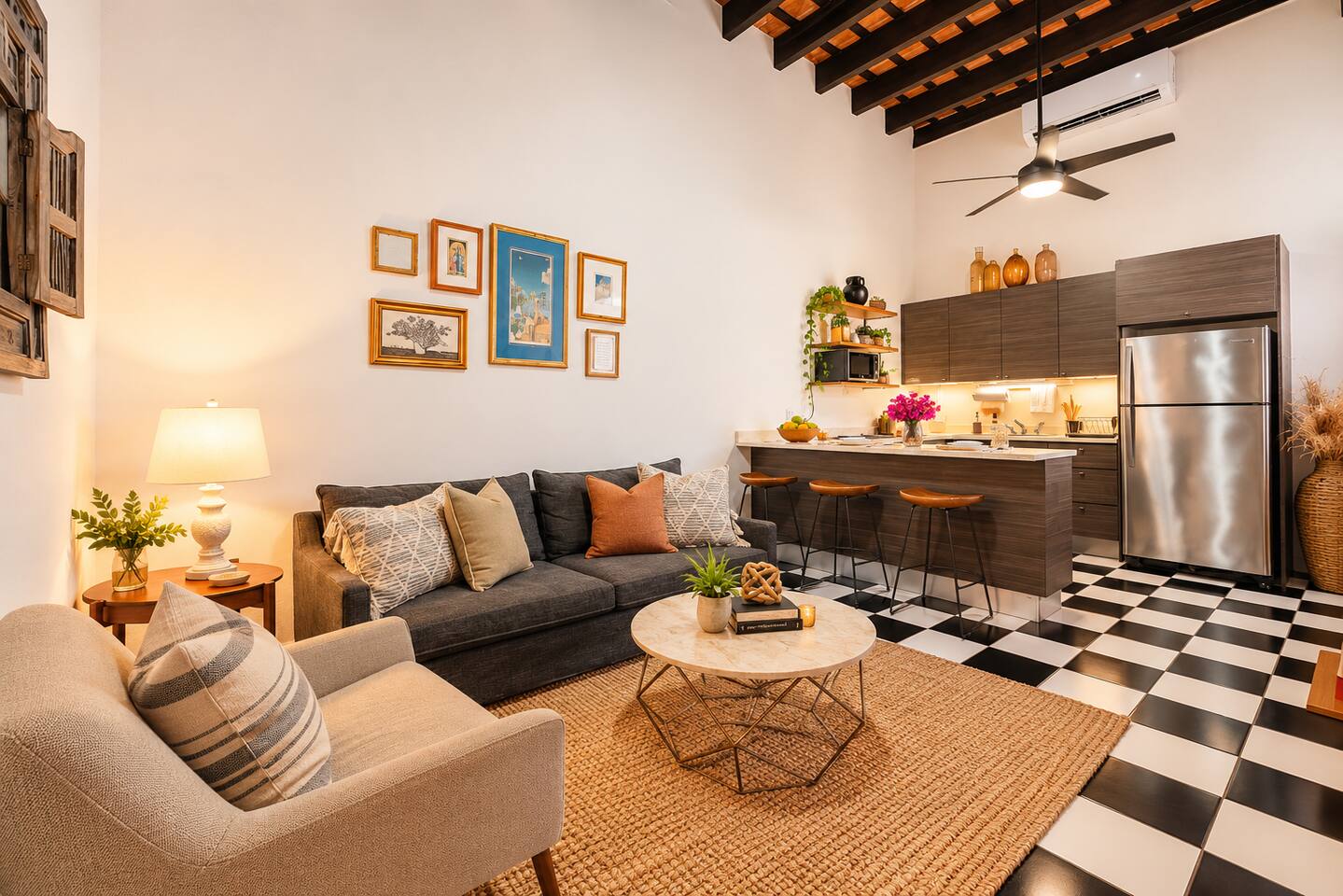Gather, relax, & reconnect in this spacious living area with soaring ceilings, exposed wooden beams, & charming Colonial details. Enjoy comfortable seating, a fully equipped kitchen, and a breakfast bar perfect for sharing meals and making memories.