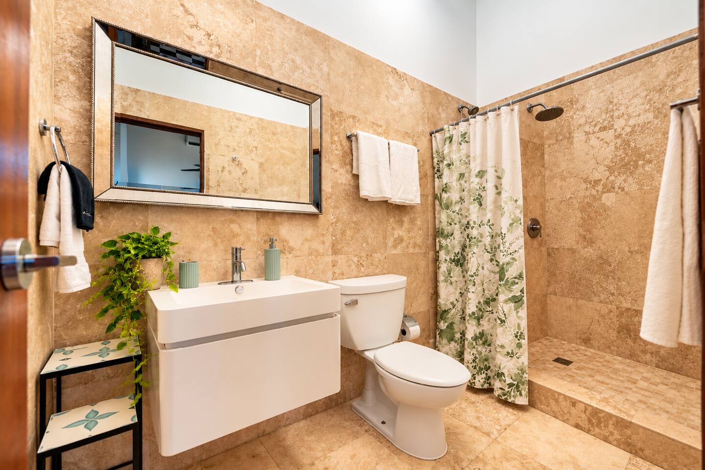 Freshen up after a day exploring Old San Juan in this inviting full bathroom with natural stone tile and a walk-in shower. Thoughtfully stocked with shampoo, conditioner, body wash, fresh towels, washcloths, makeup removal towels, and a hair dryer.