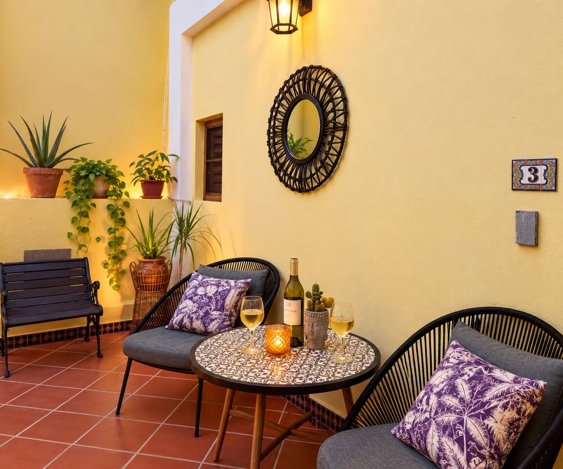Outdoor seating area just outside your door, overlooking the peaceful yoga courtyard below—perfect for coffee, fresh air, or unwinding in the Caribbean breeze.