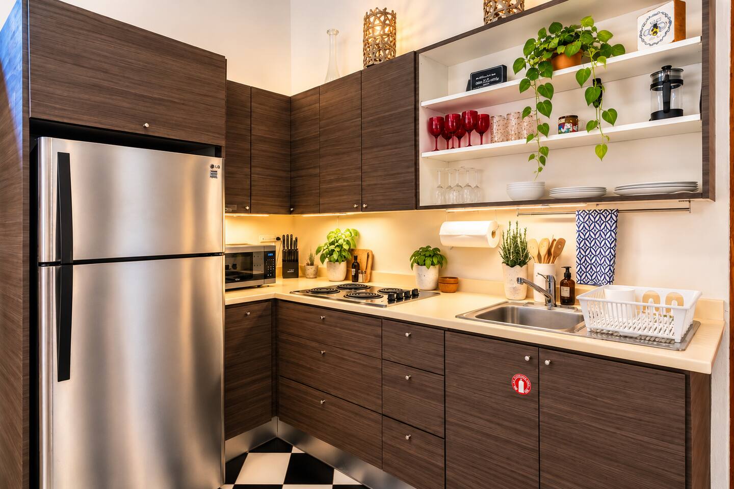 A stylish, fully equipped kitchen with stainless steel appliances, a four-burner cooktop, microwave, French press, and everything you need to prepare a romantic dinner or leisurely breakfast before exploring the colorful streets of Old San Juan.