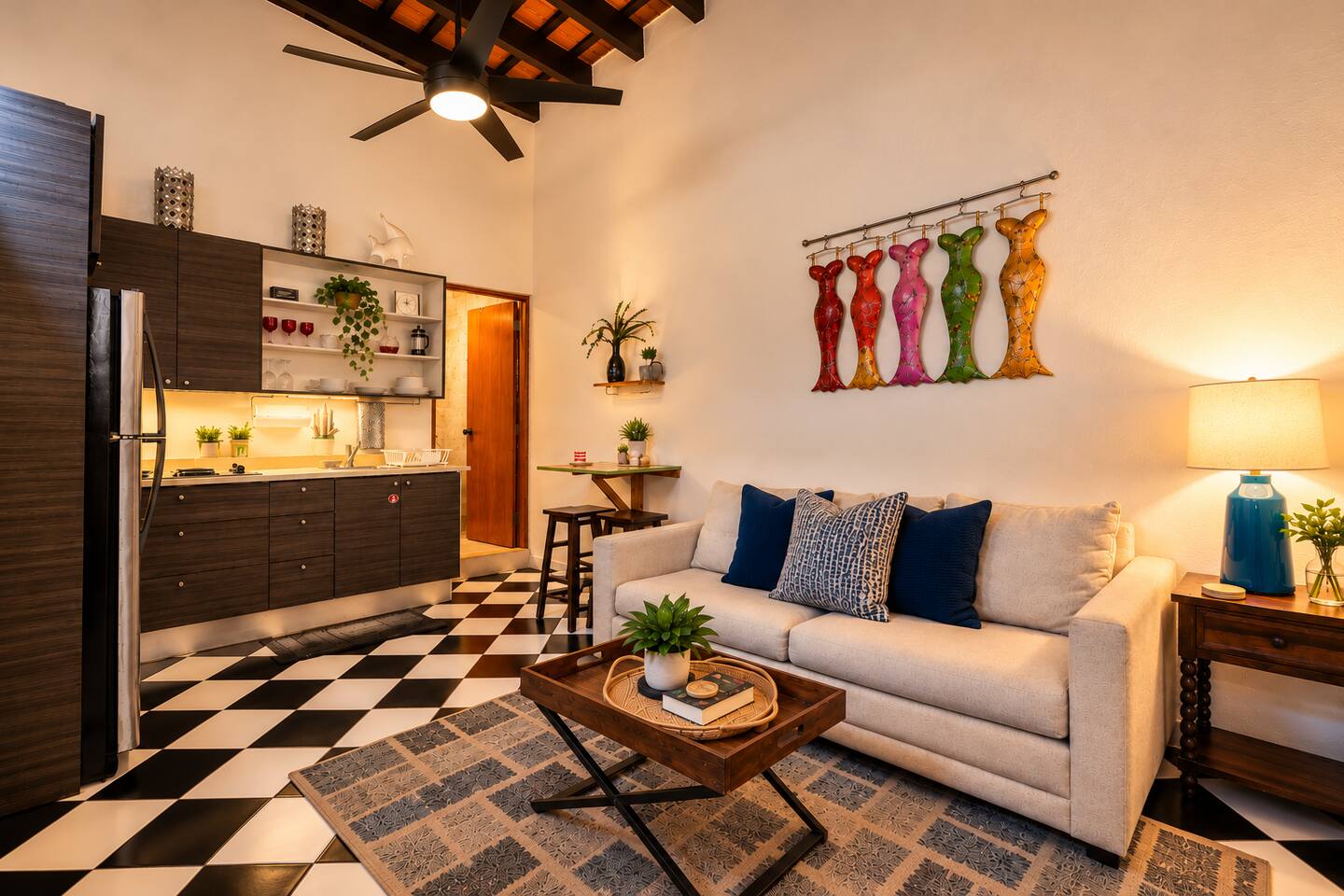 Warm, inviting living space with soaring ceilings, exposed Spanish Colonial beams, a comfortable sofa, and a fully equipped kitchenette. Relax after exploring Old San Juan or enjoy a quiet meal in your own cozy retreat.