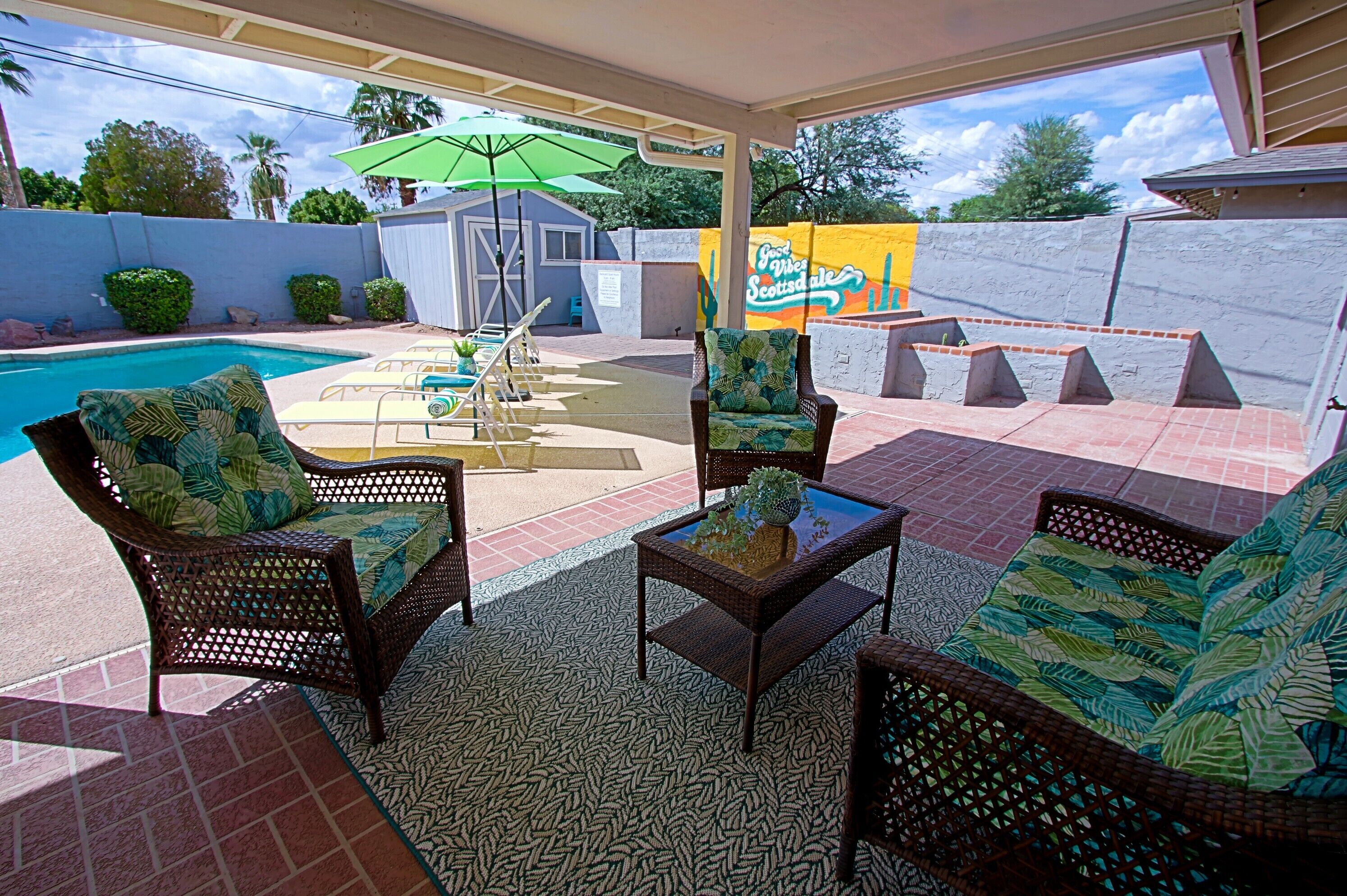 Shaded conversation area overlooking the pool. Great for year-'round chats!