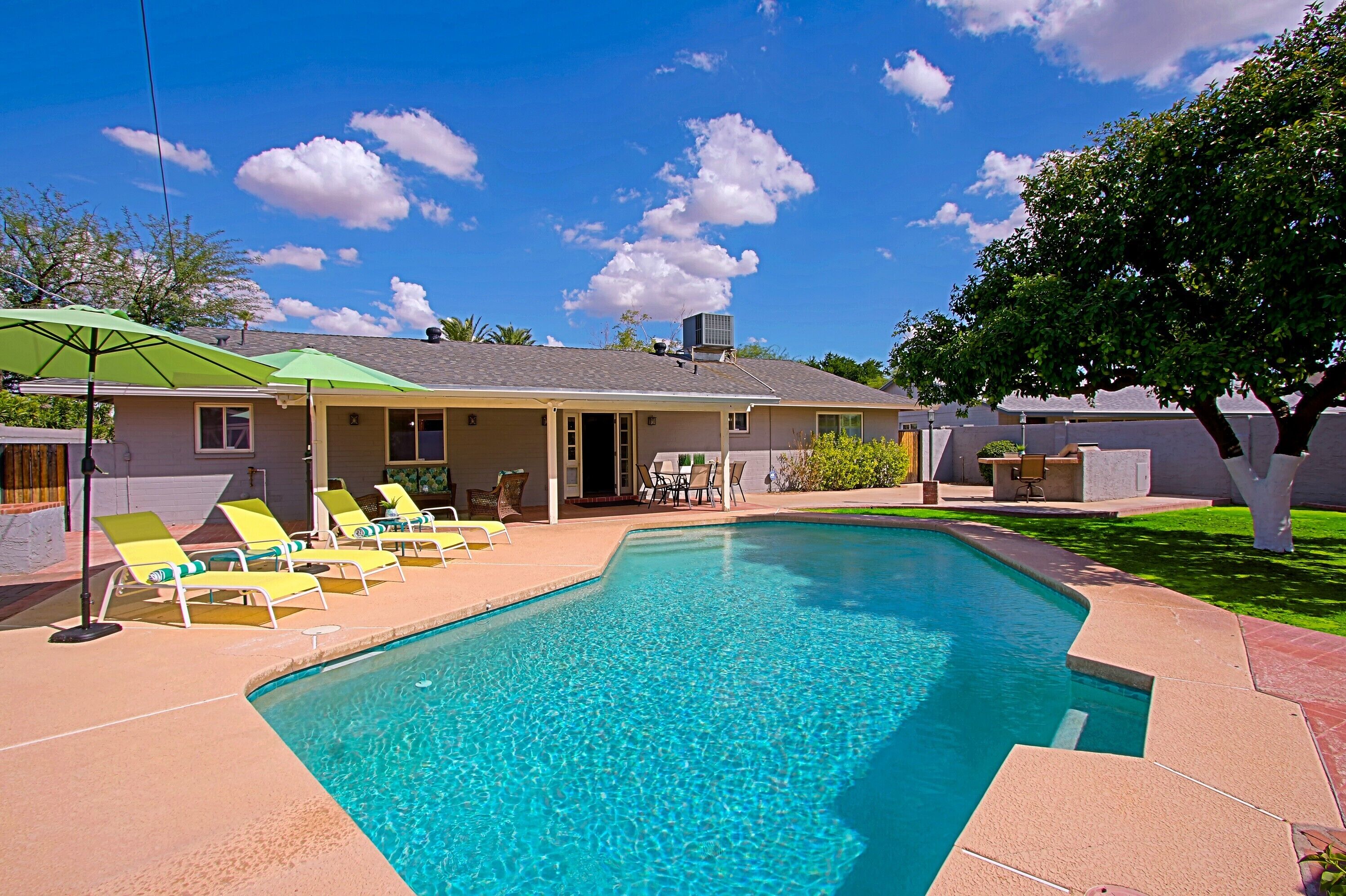 View of the house and heated pool. A dreamy year-'round oasis! Grapefruit tree?