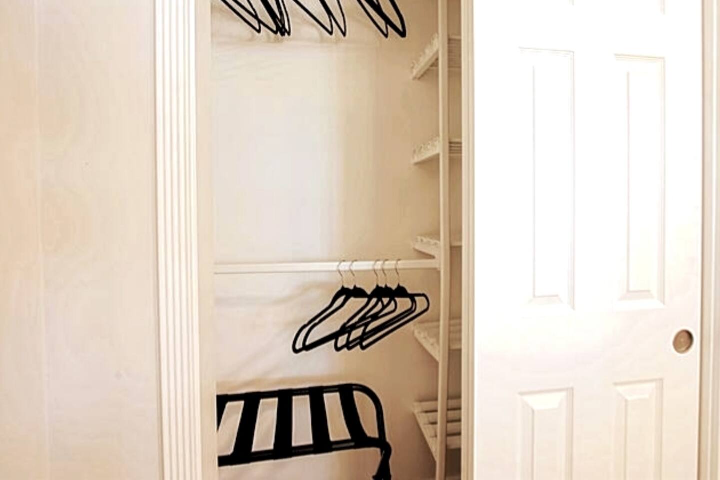 Hangers and luggage rack in every closet. This is the bunk room closet.