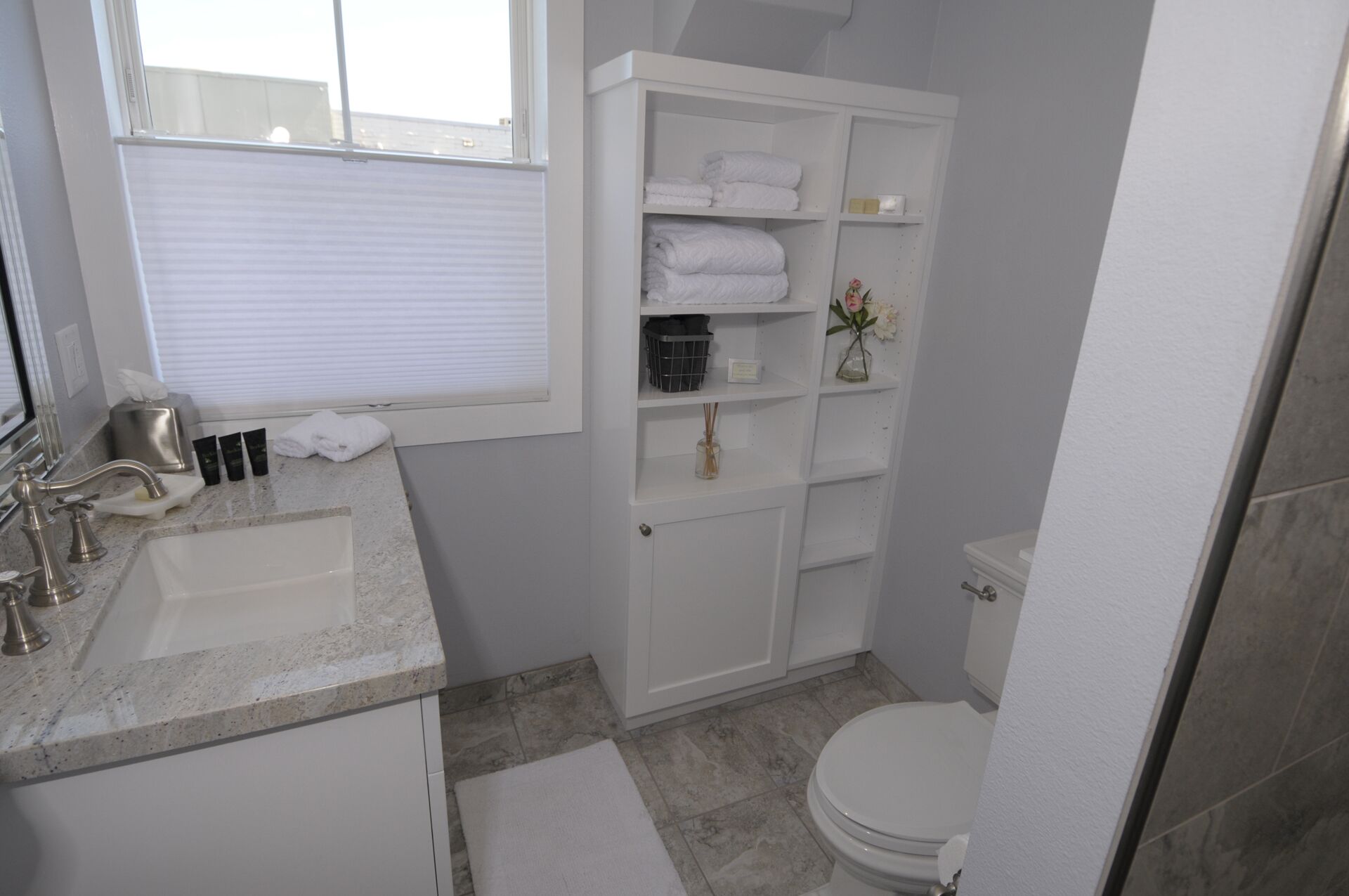 Full size bathroom updated with modern amenities as well as toiletries.