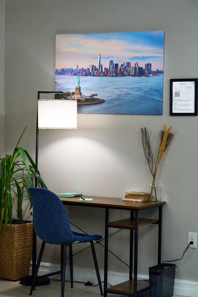 Enjoy the freedom to get work done with your desk and lamp.

Lamp features remote control to change light settings and a foot control right below the desk for your convenience.

Space also includes custom art work  of NYC and Statue of Liberty.