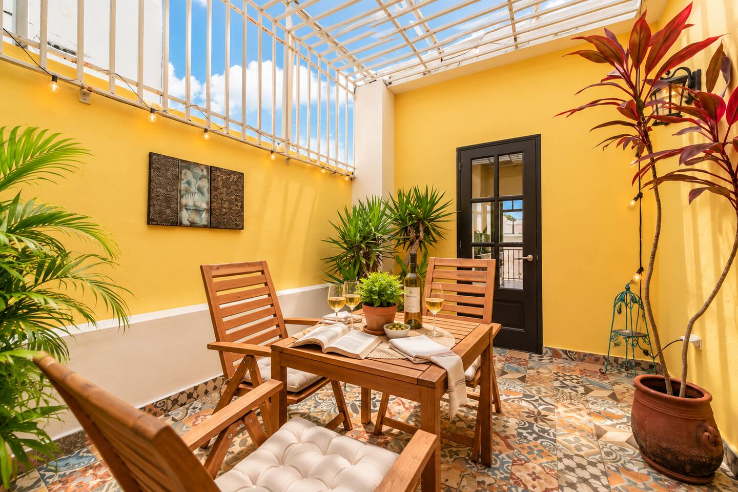 Escape to your own charming private patio, surrounded by sunny yellow walls, tropical greenery, and beautiful patterned tiles. Enjoy morning coffee, afternoon reading, or a glass of wine under the Caribbean sky in this peaceful Old San Juan retreat.