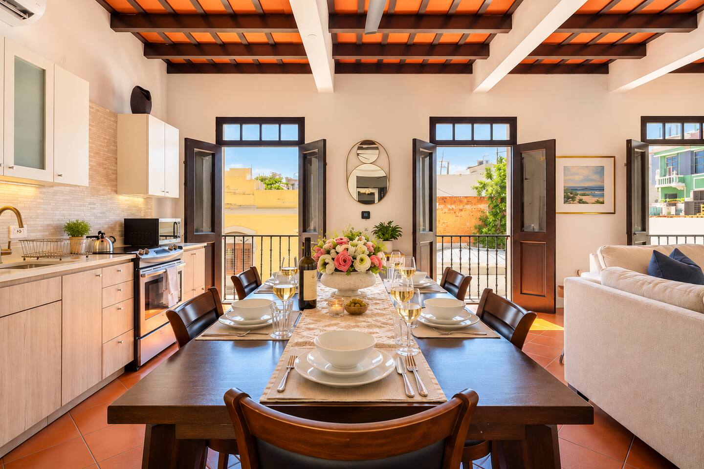 Gather around the dining table for a memorable meal with family and friends. This bright, open space features a fully equipped kitchen, beautiful exposed-beam ceilings, and French doors opening to Juliet balconies overlooking colorful Old San Juan.