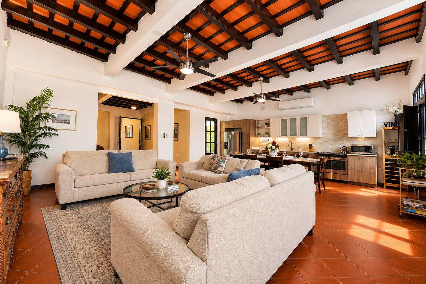 Gather with family and friends in this spacious, open living area featuring comfortable seating, a fully equipped kitchen, & dining space for everyone. Soaring ceilings with exposed wooden beams and terracotta floors add authentic Old San Juan charm.