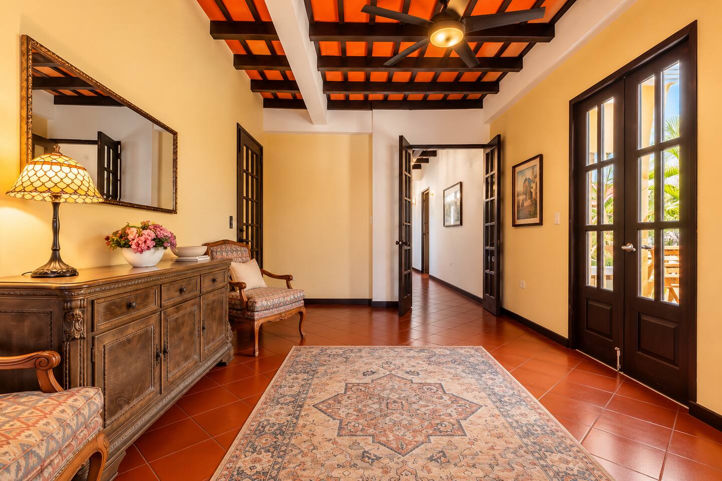 Step into Old San Juan elegance! Our spacious foyer welcomes you with wood-beamed ceilings, terracotta floors, antique furnishings, and warm Caribbean charm. A beautiful introduction to your home away from home in the heart of the historic city.