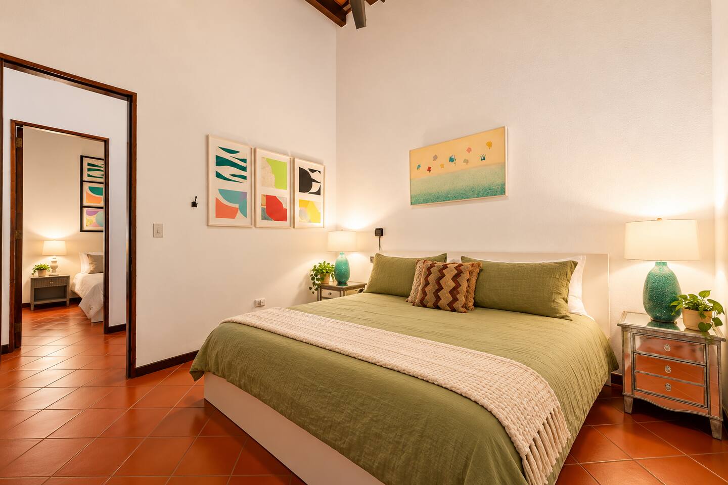 Unwind in this peaceful bedroom featuring a plush king bed, whisper-quiet A/C, and ceiling fan for year-round comfort. Soft lighting, colorful artwork, and Caribbean-inspired décor create the perfect retreat after exploring Old San Juan.