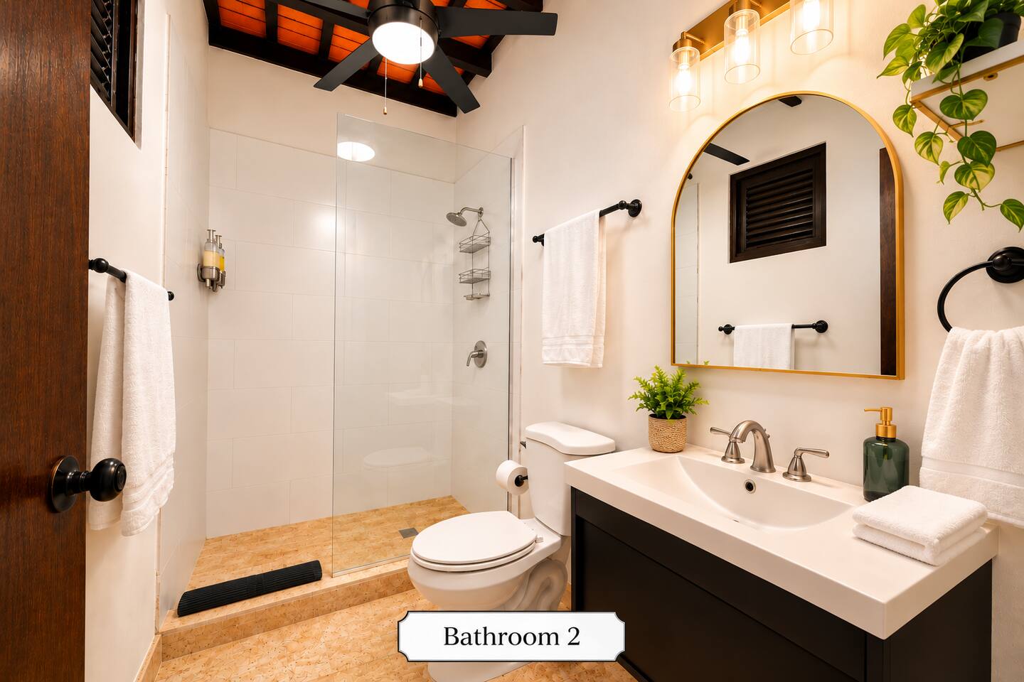 The fully stocked second bathroom features a spacious walk-in shower, modern vanity, fresh towels, and thoughtful essentials, offering guests comfort and convenience throughout their stay.