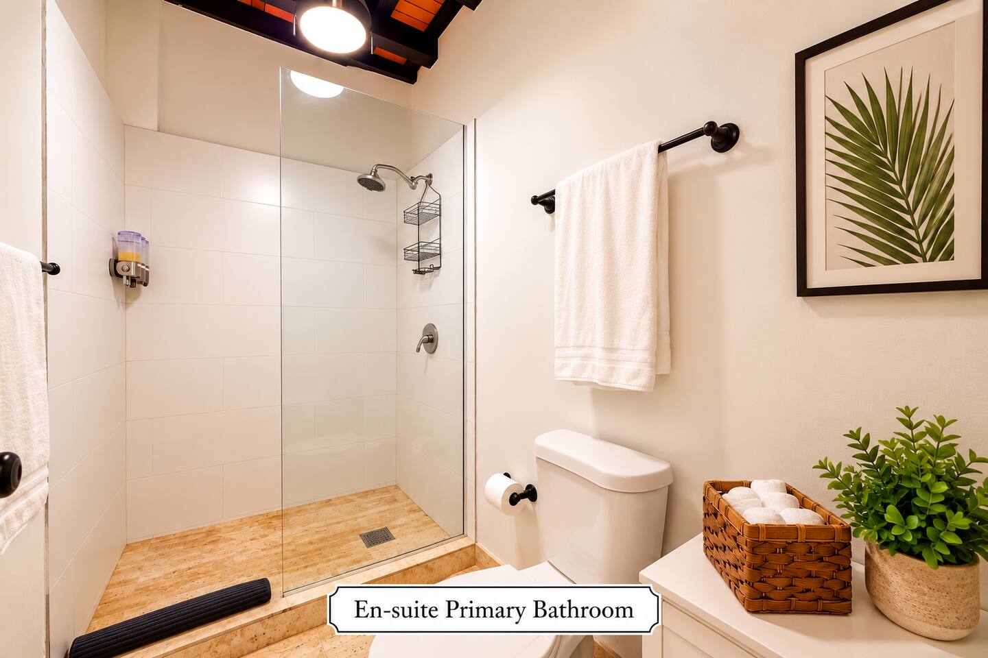 The primary en-suite bathroom features a spacious walk-in shower blending modern comfort with Old San Juan’s historic charm.