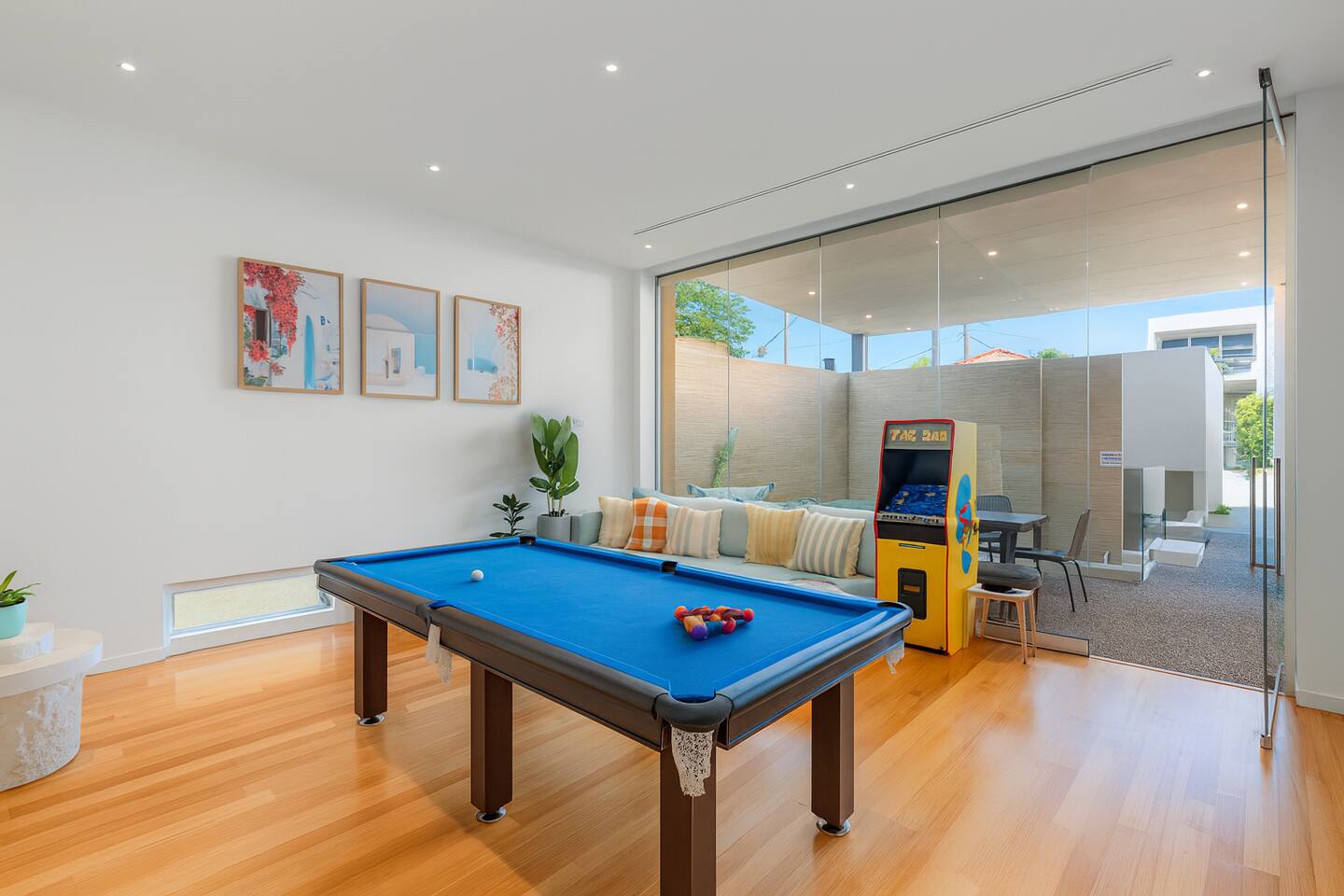 Games room with pool table and Pac-Man opening onto the courtyard