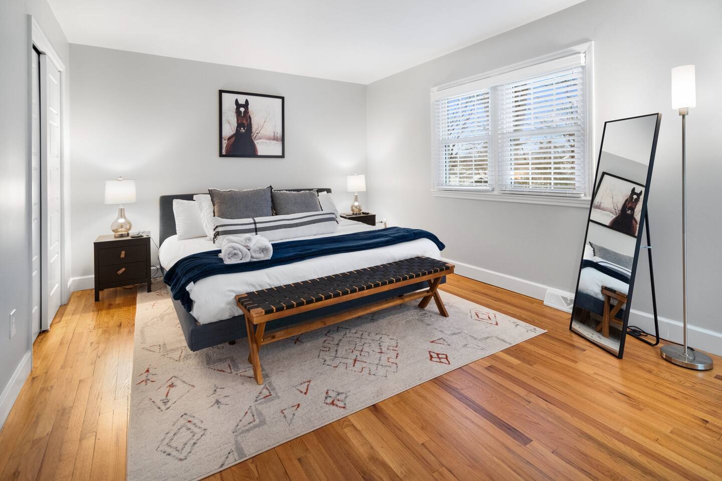 Master bedroom with a king bed and equestrian-themed decor