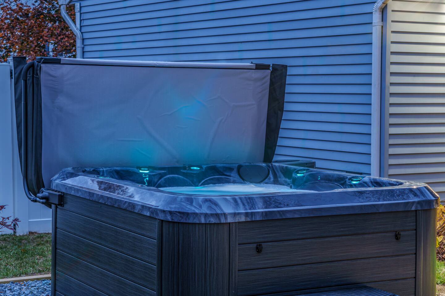 Private hot tub glowing with LED light at night