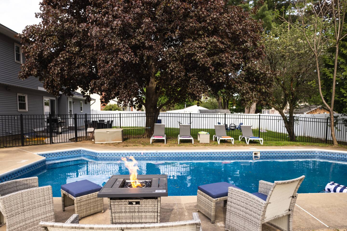 Heated pool with loungers in a fenced private yard at Walters Retreat