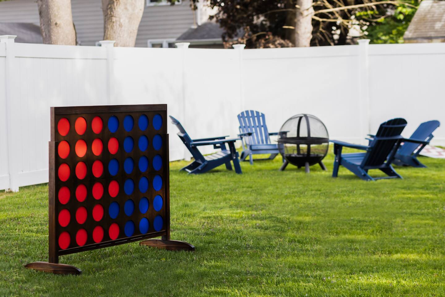Expansive lawn set up for life-size games and a fire pit